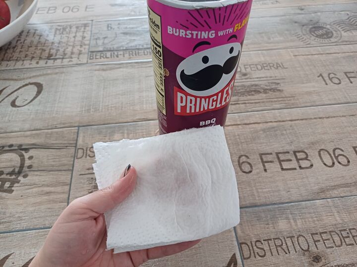 Wiping the inside with vinegar removes any leftover Pringles smell for a fresh start.