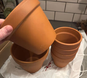 She uses a stack of flower pots for the coolest wall idea we've seen in a long time