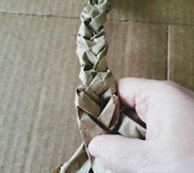 She starts braiding strips of brown packing paper for an Easter idea we've never seen