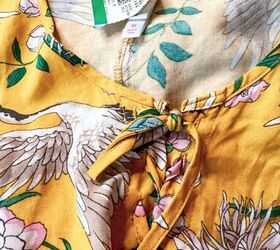 She lays some plain picture frames on an old dress for this gorgeous decor idea