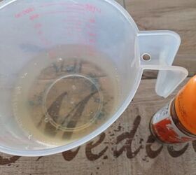 Pour white vinegar into a jug. It’s the key ingredient that starts the weed-zapping magic