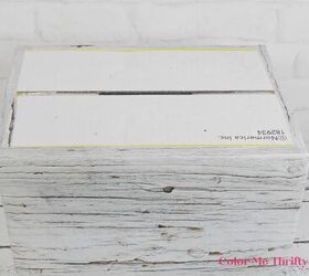 cat litter cardboard box makeover, applying wall stickers around bottom edge of cardboard box