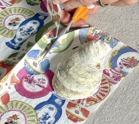 She places some oyster shells on a decorative napkin like this for this easy and fun wall art idea