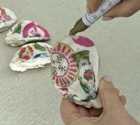 decoupage shells as wall art diy oyster shell flowers, Using a gold paint pen to outline the edge of decoupage shells