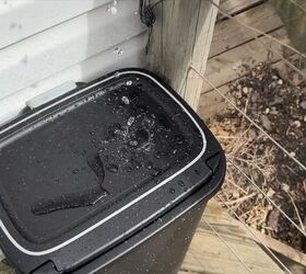 Trash can rainwater barrel installed on a deck under a downspout 