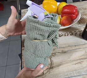 Spray bottle with the mixture, wrapped in a towel and secured with an elastic band
