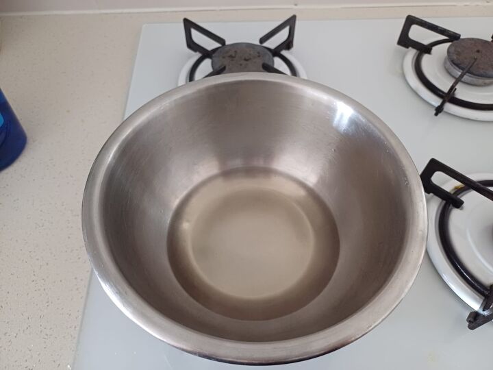 The pot with the mixture sitting on a stovetop heating up.