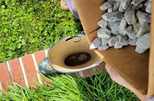 She pours rocks into an old rain boot for this sweet porch accent