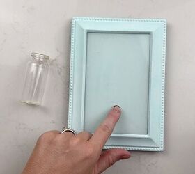 Why she glues a magnet inside an old picture frame