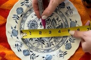 She drills a hole through an old plate to get the prettiest kitchen accent