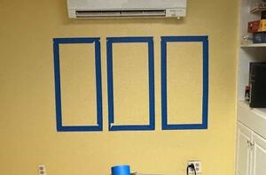 She tapes off 3 spots on her wall for a totally unique and eye-catching decor idea