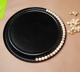Place some wooden beads around a dollar store plastic platter for this unexpected boho decor idea