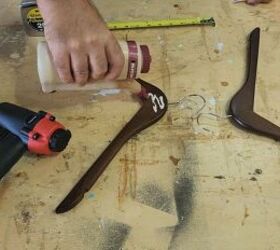 He glues 2 wooden hangers together for this jaw-dropping storage idea