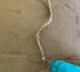 Hot glue is applied to the end of the jute