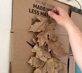 A combination of paper oak and maple leaves are applied to jute with hot glue