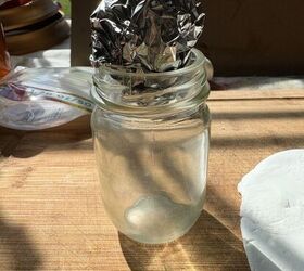 She balls up a piece of tin foil and presses it onto an empty jar for this amazing fall idea