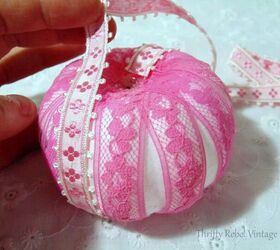 lace and ribbon pumpkins makeover, gluing ribbon between lace sections on mini pumpkin