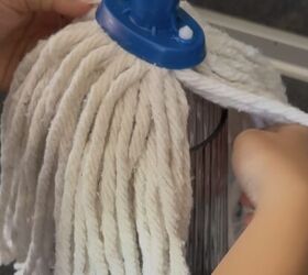 Put a mop on top of a glass vase for this clever fall hack