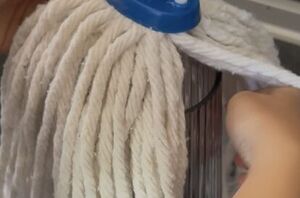 Put a mop on top of a glass vase for this clever fall hack