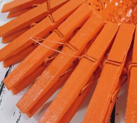 repurposed clothes pins into fall flowers, attaching fishing line to backs of clothes pin fall flowers