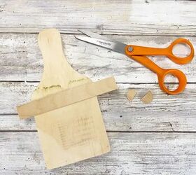 Lay a popsicle stick on a cutting board for this cute fall idea