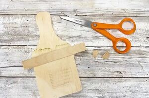 Lay a popsicle stick on a cutting board for this cute fall idea