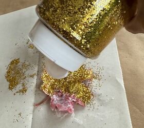 She sprinkles glitter on faux leaves for this dazzling fall tablescape idea