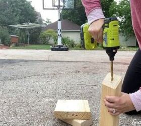 She drills a hole through some scrap wood for cute fall decor that works even after Halloween