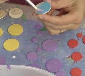 She paints little wood circles for this whimsical and festive crafting idea