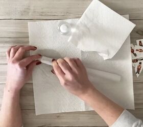 She lays a candle on a paper towel for this enchanting Christmas idea