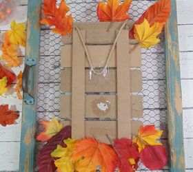 how to dress up a dollar store fall sign, gluing leaves onto back of fall sign
