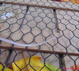 how to dress up a dollar store fall sign, curling the zip tie so it goes through chicken wire and into clip