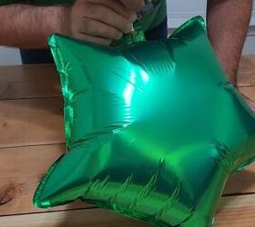 He grabs a bunch of these nylon balloons for one of the WILDEST ornament ideas we have ever seen