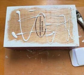 She rubed Mod Podge all over a cigar box for brilliant Christmas storage