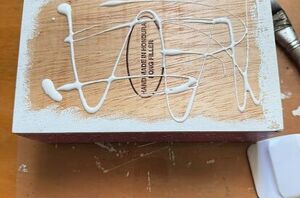 She rubed Mod Podge all over a cigar box for brilliant Christmas storage