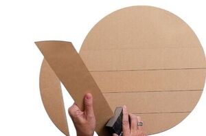 She sands the side of shiplap slabs for sweet outdoor decor