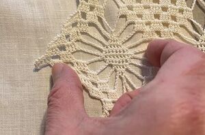 She puts an antique linen towel over her table runner to give it this elegantly nostalgic look