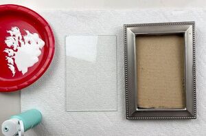 She glues a little glass tube to an old picture frame for one of the coolest wall art ideas we've seen in a while