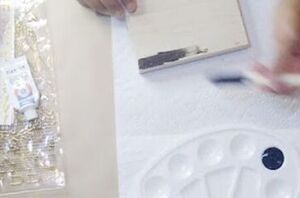 She paints 3 $1 wooden shadow boxes black to add a touch of charm to her home