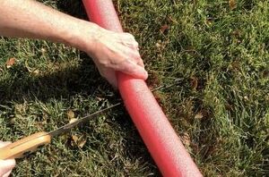 She brings a pool noodle outside to add a touch of Christmas cheer to her home