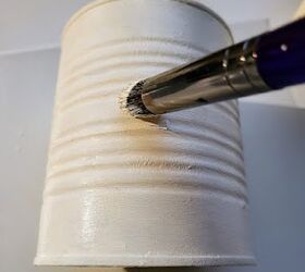 She paints an empty tin can white for the prettiest reason
