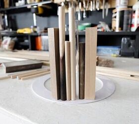 She glues a bunch of dowels to a goof ring for this exciting decor idea