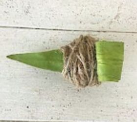 She wraps some dollar store rope around a leaf to add magical winter vibes to her home