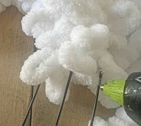 She glues some white yarn to a wire wreath for a super-cozy idea for the 14th