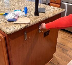 Hanging baskets on decorative command hooks to fix cluttered countertops