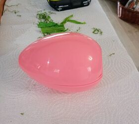 She stuffs moss into a plastic Easter egg for an Easter decor idea we did NOT see coming