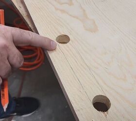 He drills 3 holes in a wooden board for one of the smartest storage hacks we've seen in a while