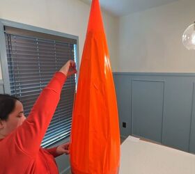 Applying long strips of orange duct tape along cone