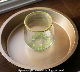 She places a candle holder in a baking pan for exquisite decor