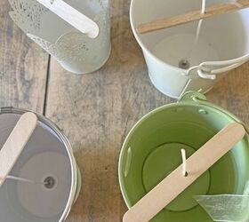 She puts popscicle sticks over little dollar store buckets to solve this annoying summer problem